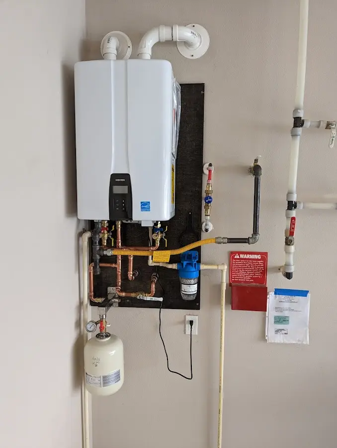 Professional plumber installing copper piping in a Dickinson home